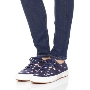 Super cute navy sneaker with pink hearts.